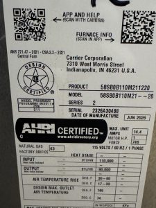 Furnace manufacturer label showing equipment model and serial number.