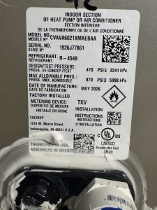 Indoor evaporator coil manufacturer label showing model and serial number.